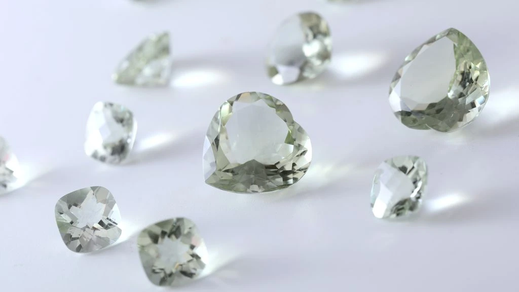 A cushion-cut aquamarine stone photographed on dark velvet, full-bleed editorial still life