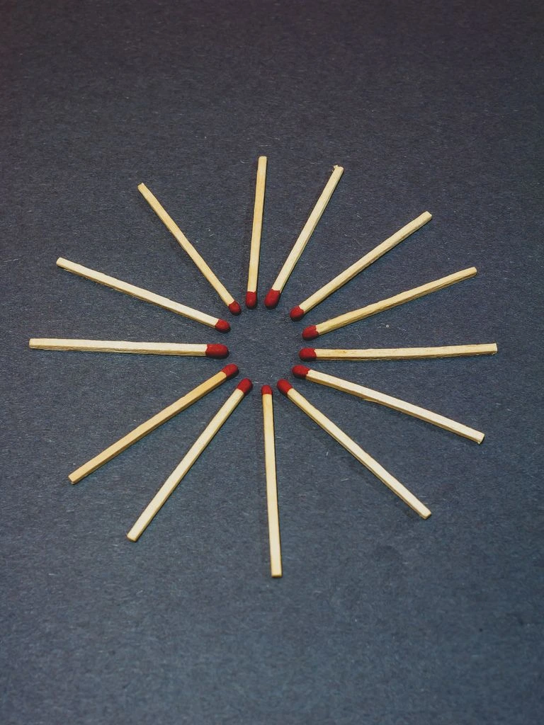 A row of eight matched round aquamarines on a grey velvet tray